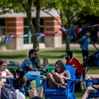 Students sitting on lawn conversing